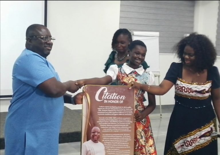 Former Child Sanitation Diplomat presents ‘mammoth citation’ to GAMA Project Coordinator for commitment to sanitation promotion